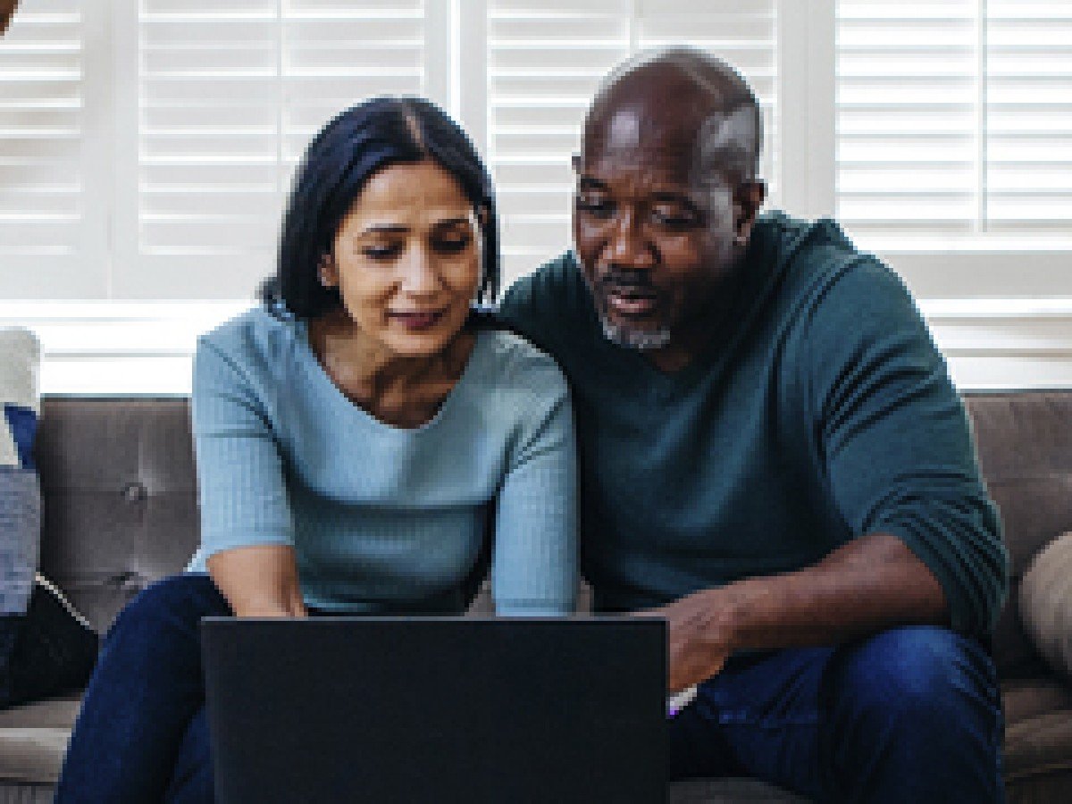 male and female viewing laptop