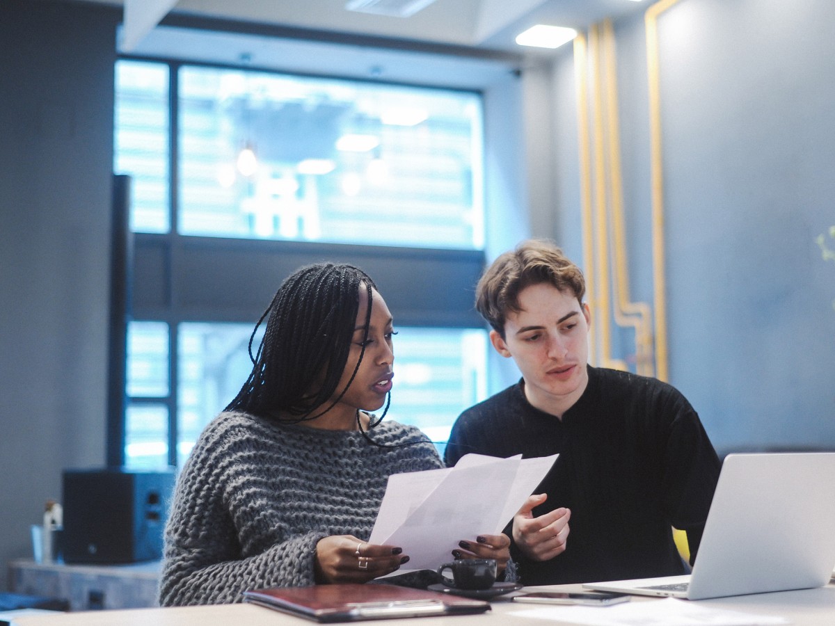 Couple reviewing papers at table