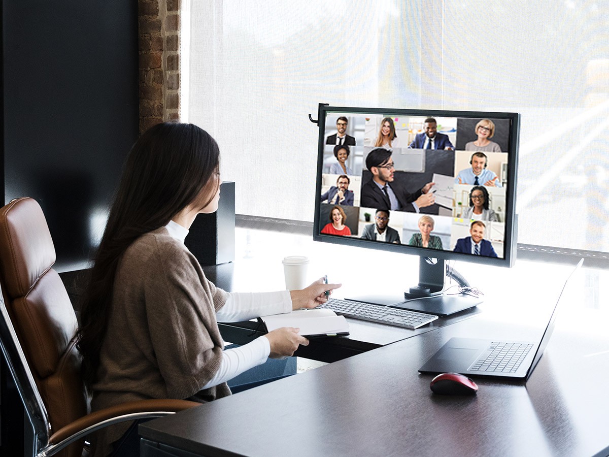 Woman sitting at a desk watching a video conference