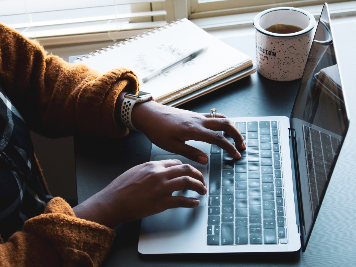 Woman's hands typing on laptop