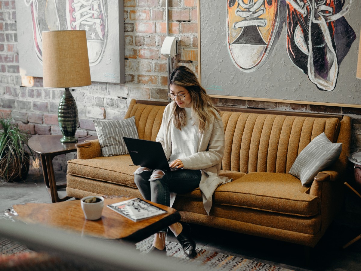 Events: Woman with laptop on couch