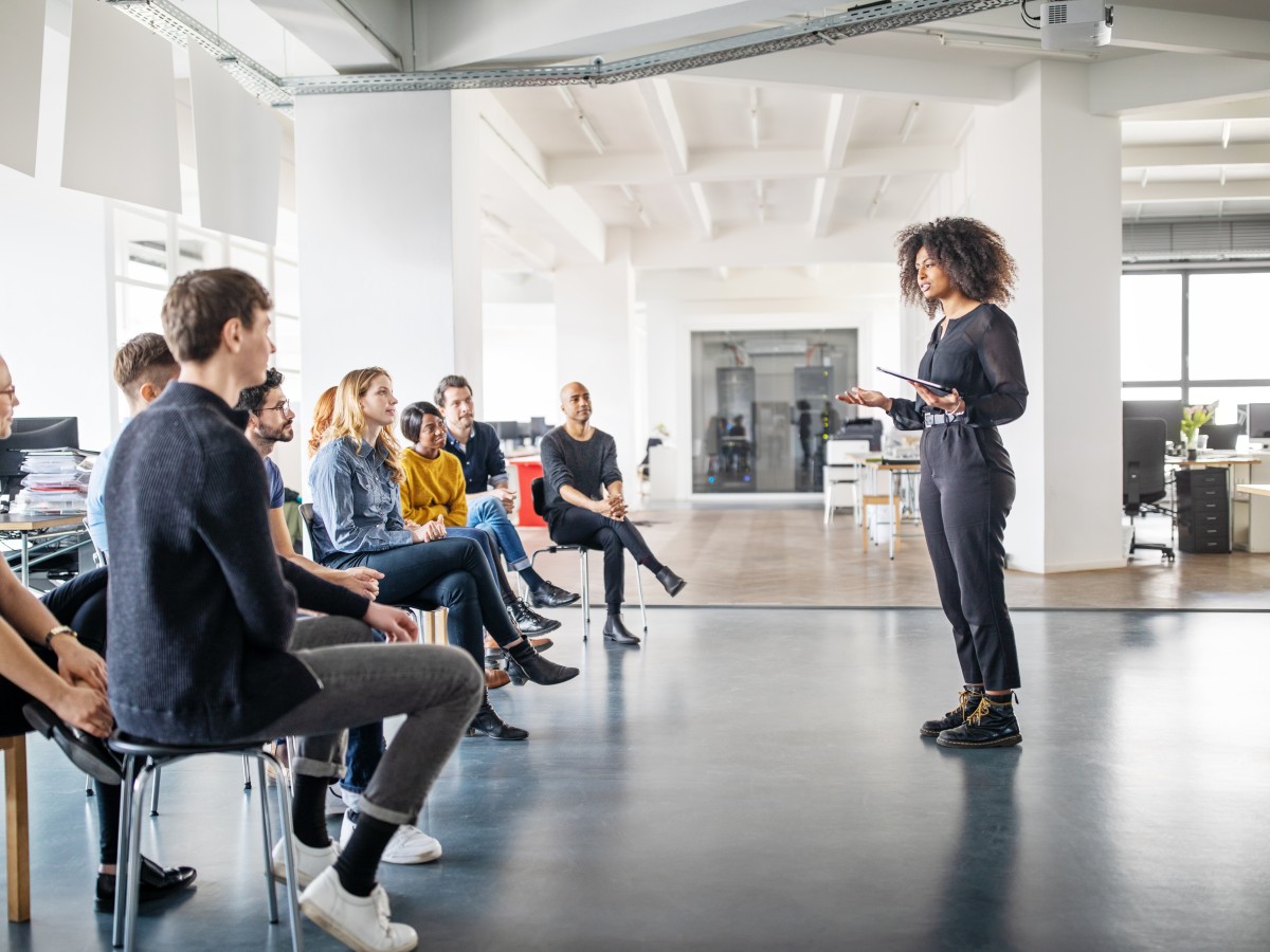 Woman giving presentation to audience