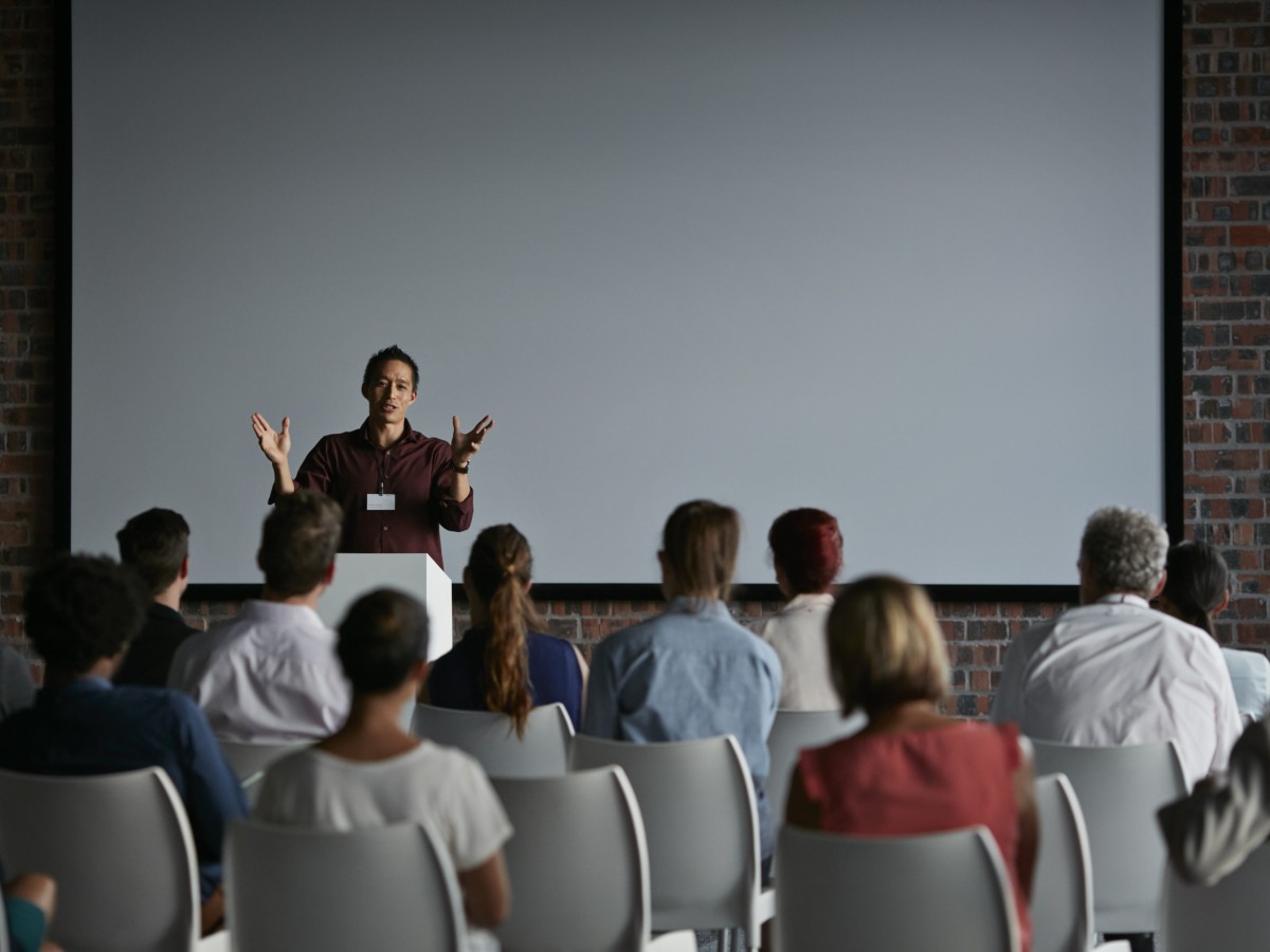 Events: Male speaking to a room of people