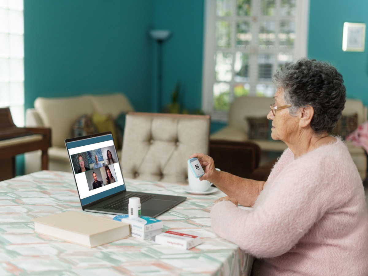 Senior woman watching webinar on laptop