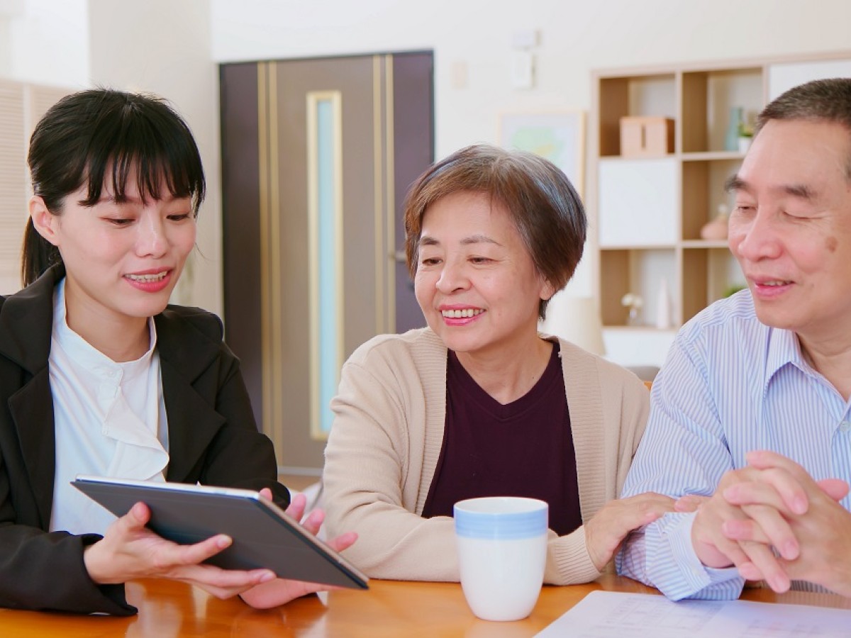 Elderly couple with young woman