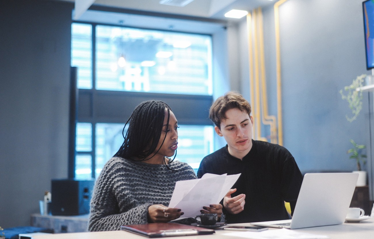 Couple reviewing papers at table