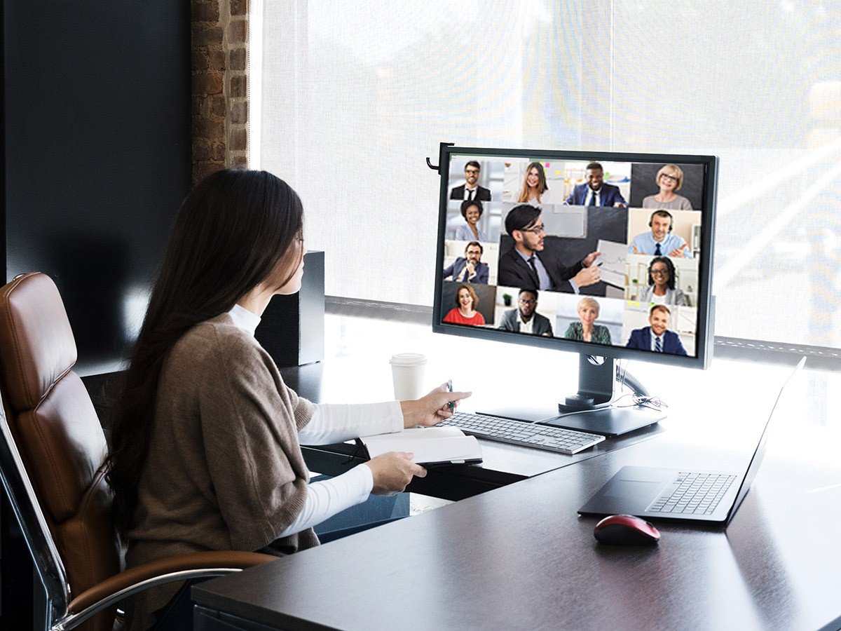 Woman sitting at a desk watching a video conference
