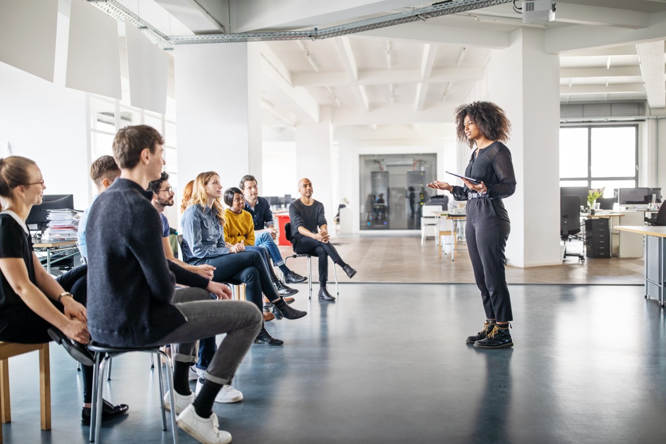 Woman giving presentation to audience