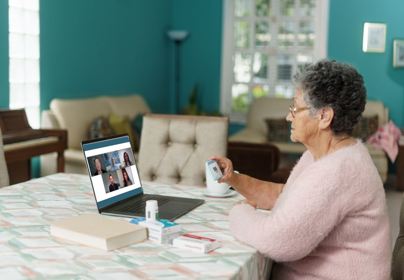 Senior woman watching webinar on laptop