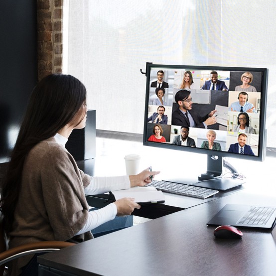 Woman sitting at a desk watching a video conference