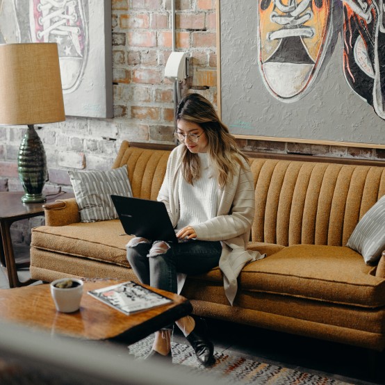Events: Woman with laptop on couch