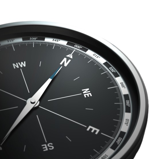 A black and silver compass pointing North