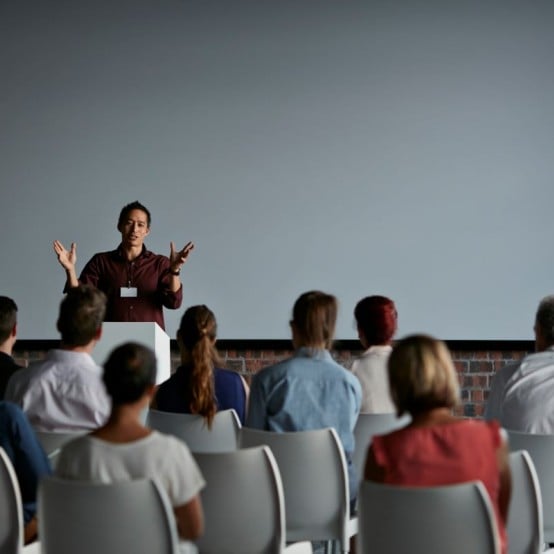 Event - Male speaker in front of a brick wall