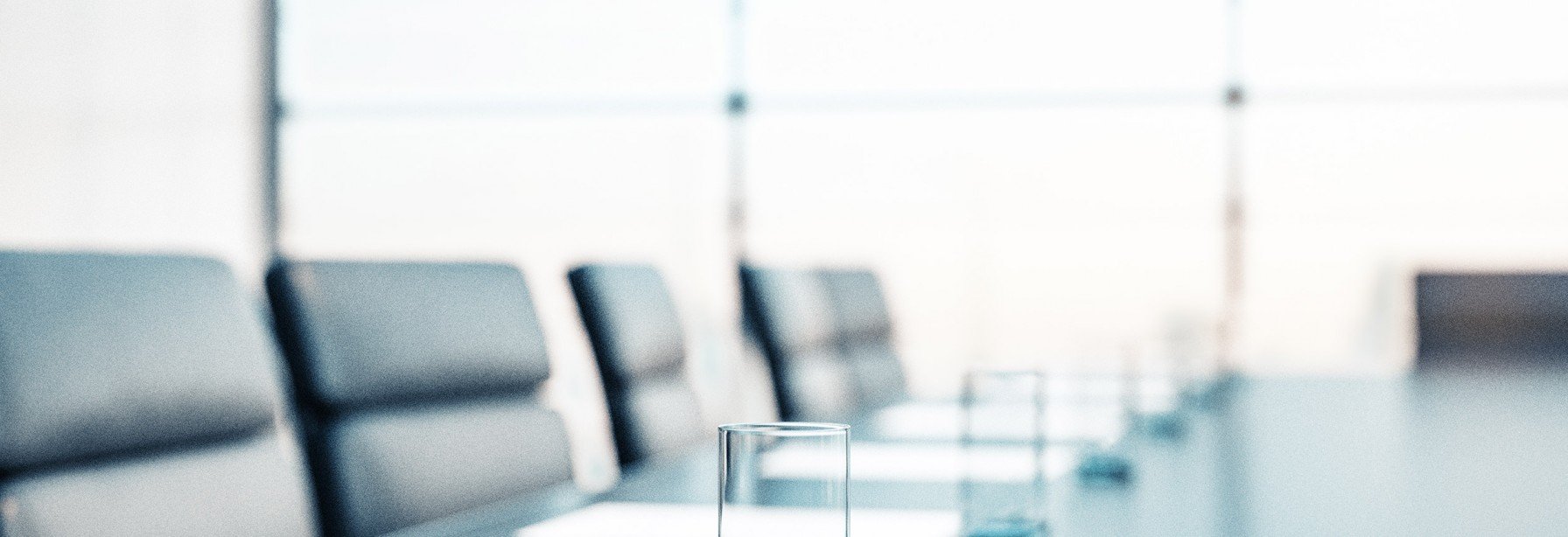 Empty boardroom with chairs and paper on the table