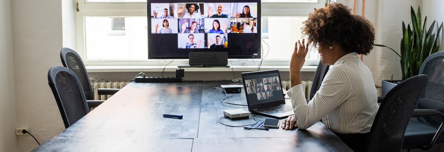 Woman sitting at a table watching a video conference call