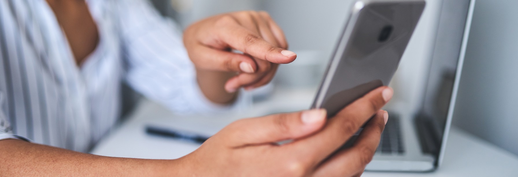 Woman sitting and looking at her phone