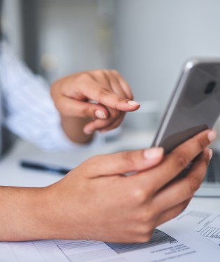 Woman sitting and looking at her phone
