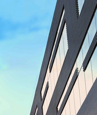 Side of office building against the sky